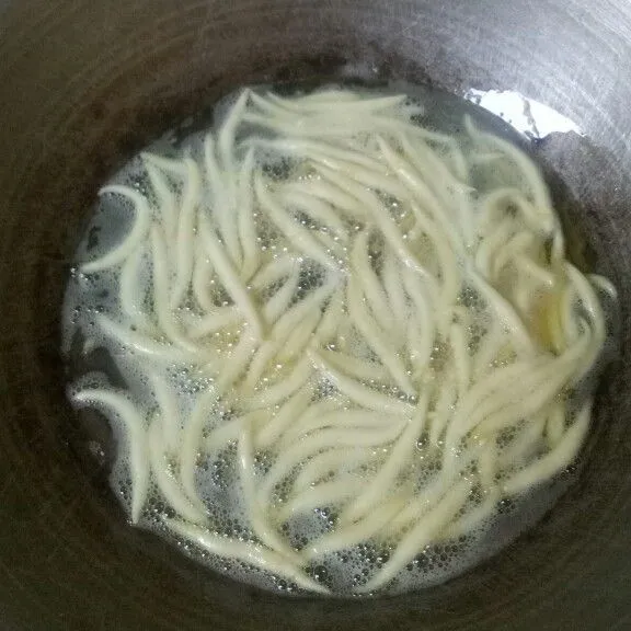 Hidupkan kompor dengan api sedang cenderung kecil, kemudian letakkan wajan yang berisi lintingan adonan. Jangan diaduk sebelum adonan terapung (supaya tidak patah).