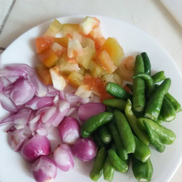 Siapkan bahan-bahannya: Cabe rawit hijau, bawang merah utuh, bawang merah cincang, dan tomat. Potong dadu.