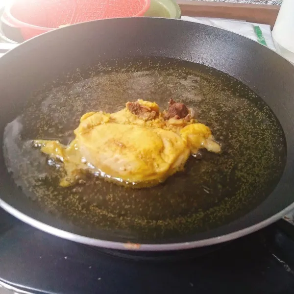 Goreng ayam dalam minyak panas hingga berwarna kuning keemasan. Angkat dan tiriskan.