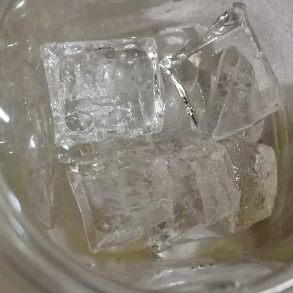Tuang es batu dalam gelas.