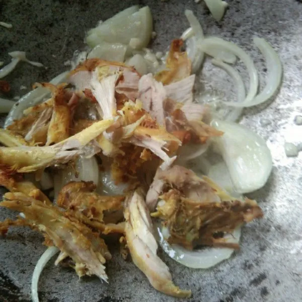Tumis bawang putih dan bawang bombay hingga harum, masukan suwiran ayam goreng, aduk rata