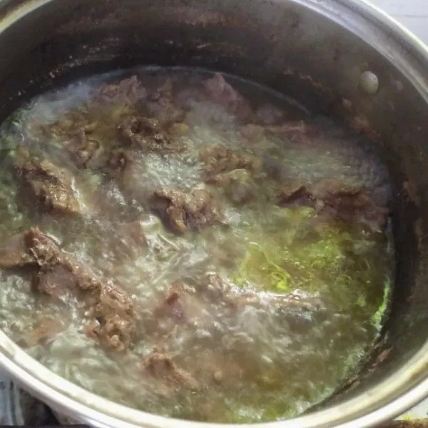 Masukkan daging yang sudah dipotong-potong ke dalam air rebusan daging.