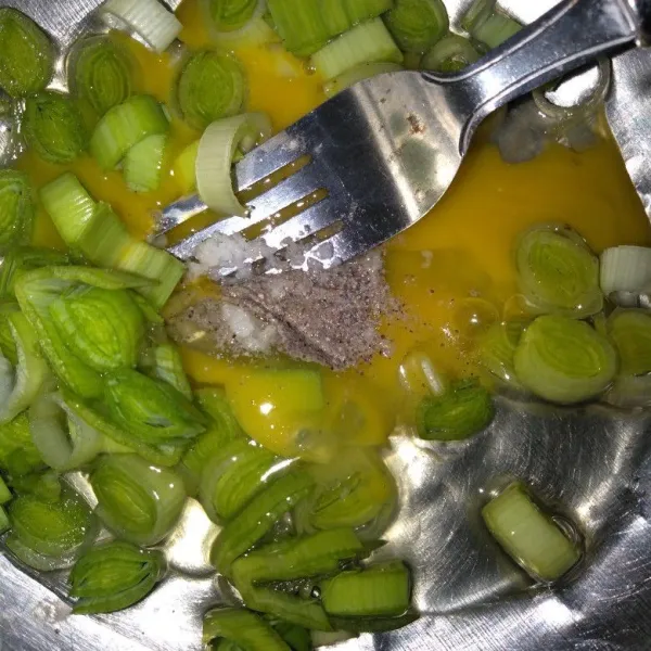 Masukkan bawang yang sudah dirajang kemudian kocok telur, merica, dan garam.