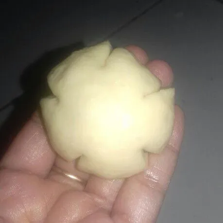 Bulatkan kembali. Kerat bagian pinggir roti dengan gunting menyerupai bentuk bunga.