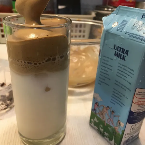 Tuang dalgona di atas susu.