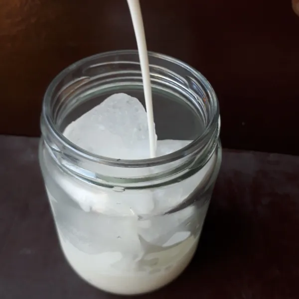 Tuangkan susu cair sampai jar hampir penuh.