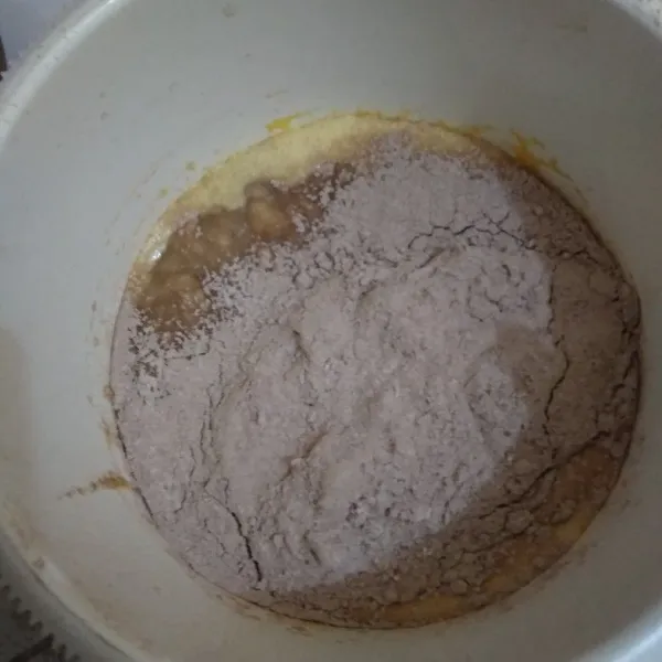 Tambahkan tepung terigu dan coklat bubuk yang sudah diayak. mix asal rata.