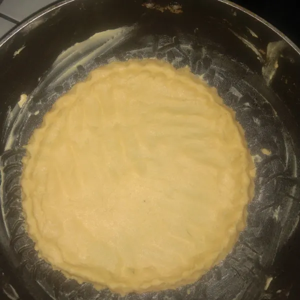Setelah itu masukkan ke dalam teflon yang sudah dioles margarin. Bentuk adonan dan tusuk mengunakan garpu.