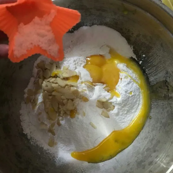 Masukkan telur, garam, almond, mentega ke dalam adonan terigu.