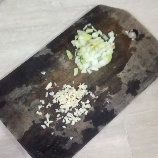 Cincang bawang putih dan bawang bombay.