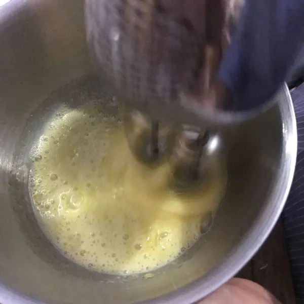 Siapkan wadah. Masukkan telur, gula, pengembang kue. Mixer dengan kecepatan sedang sampai adonan putih, kental.