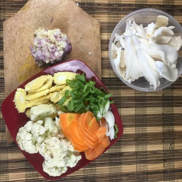 Cincang kasar bawang merah dan bawang putih kemudian kupas dan iris serong wortel, baby corn. Suwir wortel serta kembang kol.
