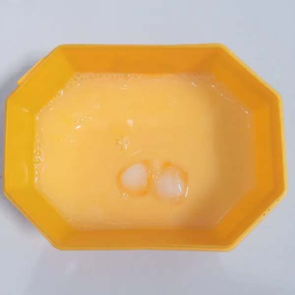 Kocok kuning telur. Tambahkan air es dan 2 kotak es batu. Aduk rata.