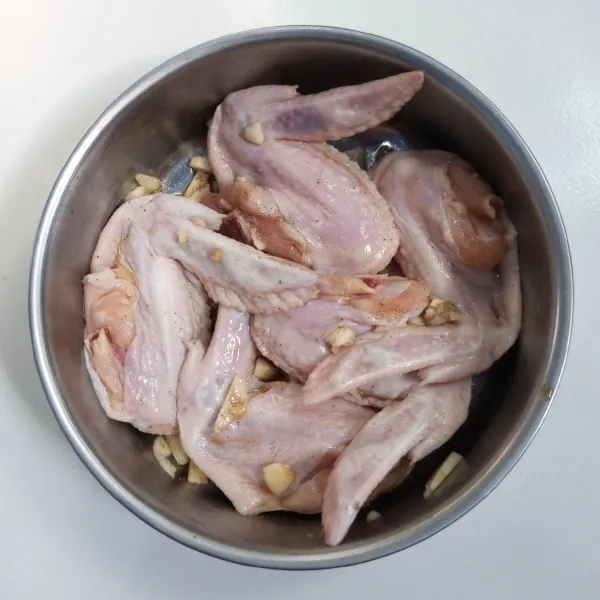 Cuci bersih sayap ayam. Kemudian balur dengan bumbu perendam. Diamkan selama 1 jam.