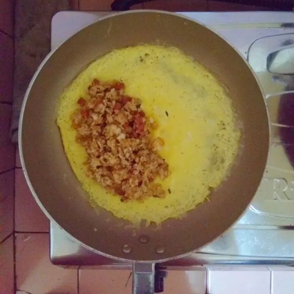 Tunggu hingga telur dadar matang kemudian masukkan nasi goreng.