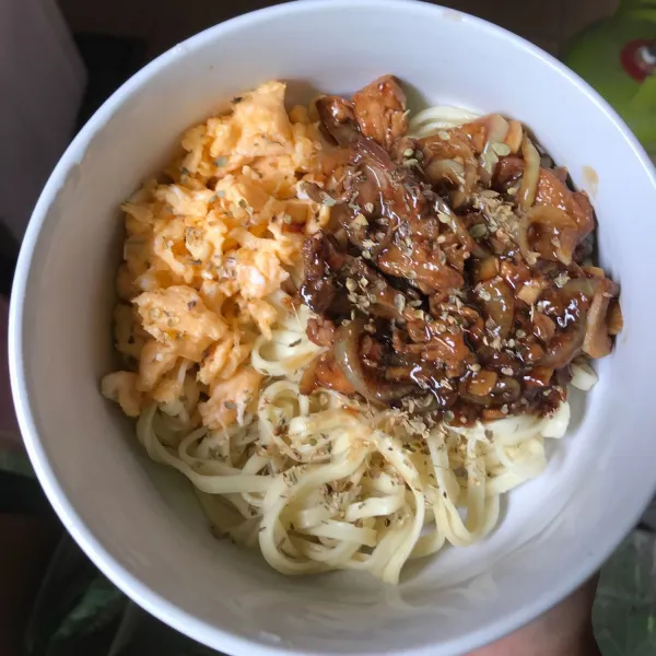 Siapkan mangkuk letakkan mie, lalu telur dan ayam lada hitam diatasnya. Taburi dengan oregano.