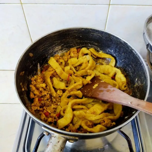 Tambahkan kecap, air, garam, gula, lada,. dan mie yang telah direbus. Aduk hingga rata.