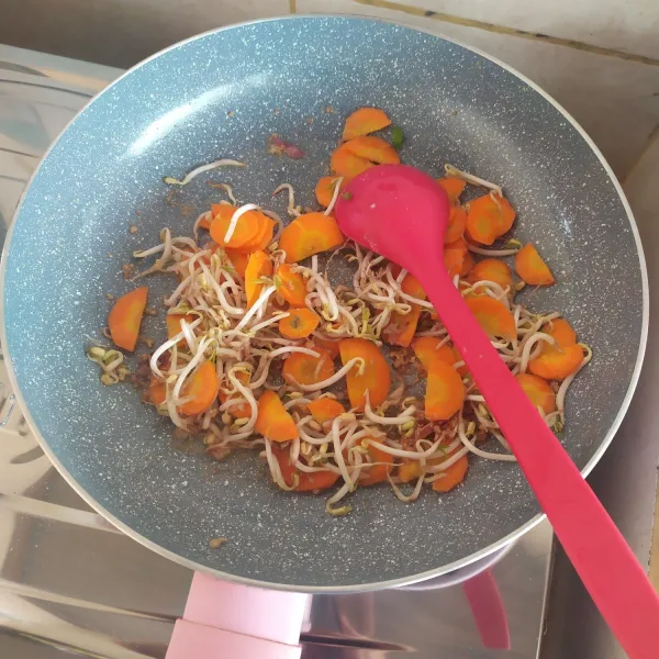Panaskan minyak, tumis bumbu halus hingga harum. Masukkan wortel dan tauge.
