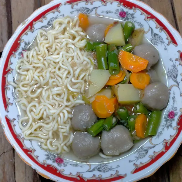Campur mie ke dalam sayur sop, sajikan hangat.