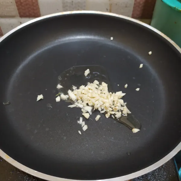 Tumis bawang putih hingga harum.