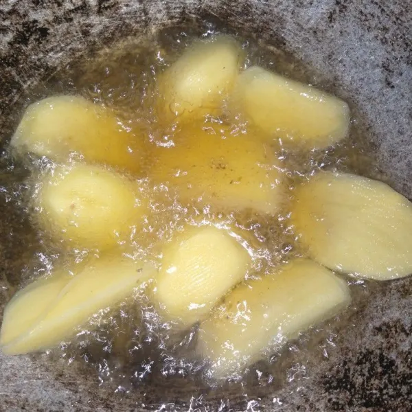 Kupas kulit kentang kemudian potong memanjang, panaskan minyak dan goreng kentang hingga matang.