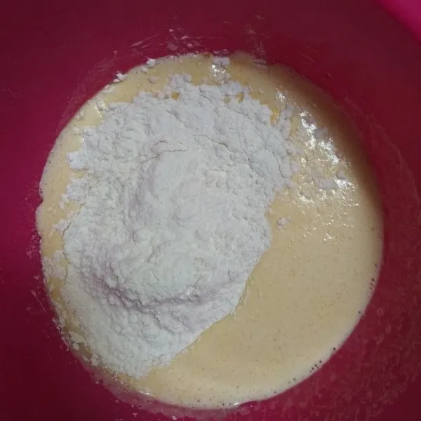 Masukkan tepung dan mentega cair, aduk hingga rata.