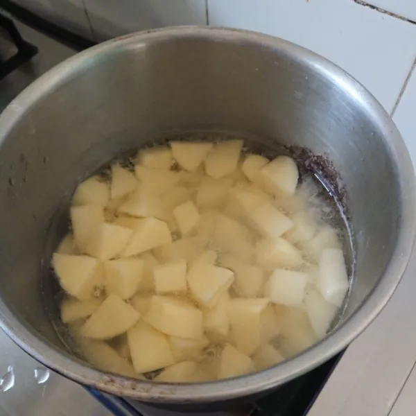Rebus kentang lalu tambahkan sejumput garam dan diamkan selama 5 menit, setelah 5 menit tiriskan.