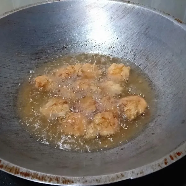 Goreng udang dalam minyak panas dengan api sedang sampai berwarna kuning kecoklatan, angkat, tiriskan, kemudian susun dalam piring saji.
