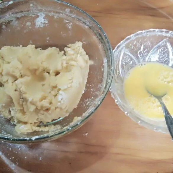 Kocok kuning telur dan air hingga rata lalu masukkan kedalam adonan sebelumnya.