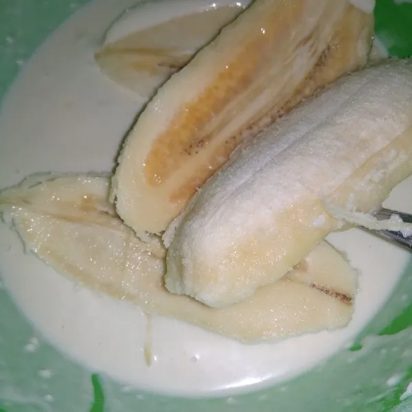 Kupas pisang belah menjadi dua, balur dengan adonan tepung