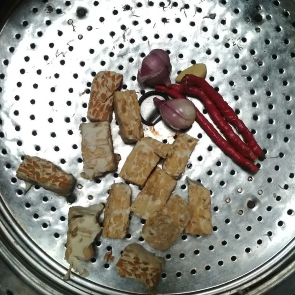 Kukus tempe yang sudah dipotong-potong, cabe merah, bawang merah dan bawang putih hingga matang