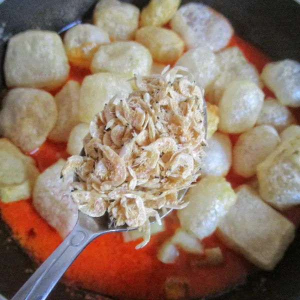 Masukkan kentang, krecek dan rebon. Masak dengan api kecil hingga kuah menyusut. Cicipi rasanya.