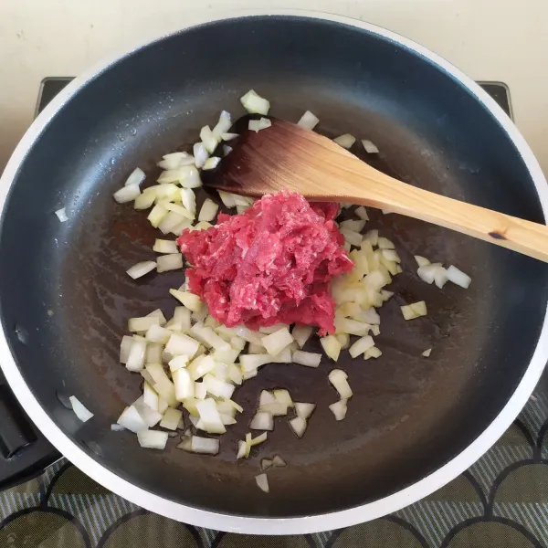 Lelehkan butter, tumis bawang bombay hingga harum.
Masukkan daging giling,tumis hingga daging berubah warna.