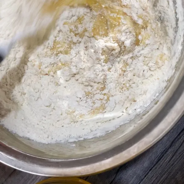 Setelah adonan menyatu, tambahkan tepung terigu, gula pasir, soda kue, dan garam. Kemudian diaduk rata.