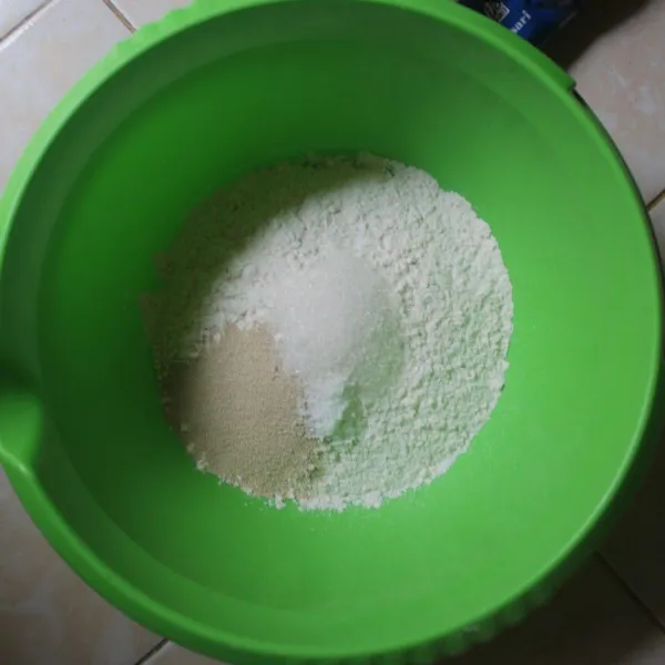 ambil wadah, masukan tepung terigu, ragi, gula pasir, garam aduk hingga rata.
