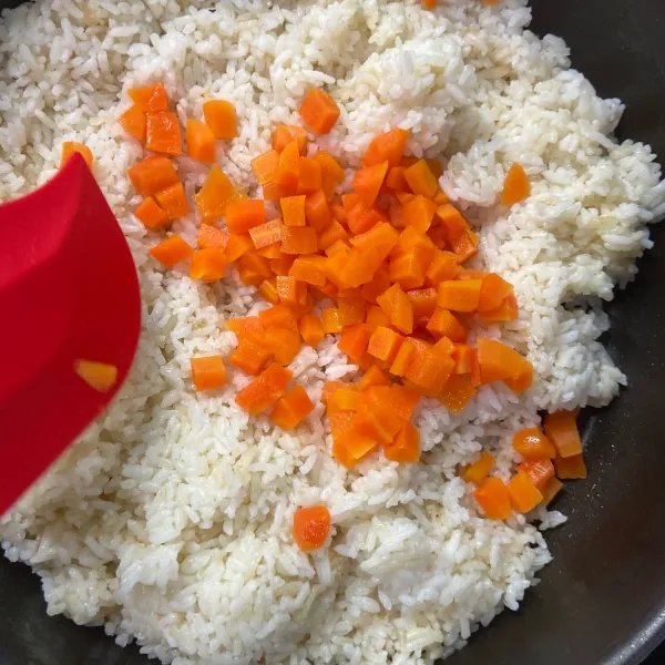 Setelah bawang matang, tambahkan nasi putih dan wortel yang sudah direbus 1/2 matang lalu aduk hingga rata
