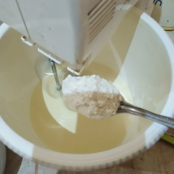 Ayak terigu dan baking powder kemudian tuang sedikit demi sedikit ke adonan telur