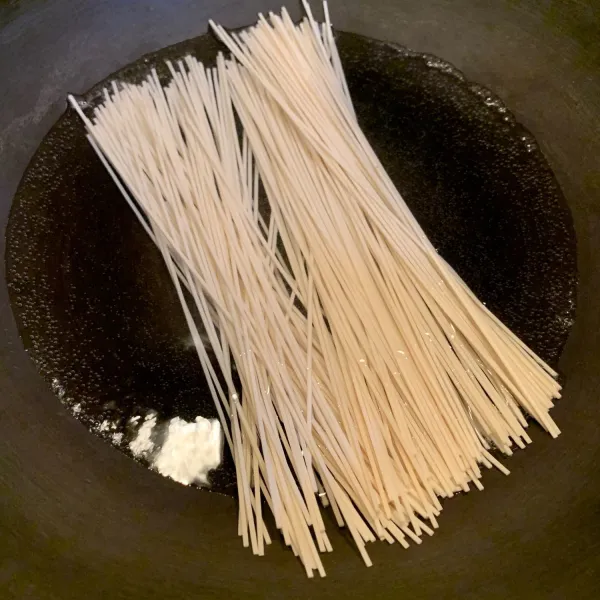 Rebus air secukupnya untuk merebus mie, setelah mendidih, masukan dan masak kurang lebih 1,5 menit. Angkat lalu tiriskan dan campurkan dengan minyak wijen supaya tidak lengket, sisihkan.