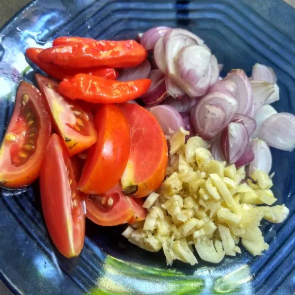 Potong-potong tomat, iris tipis bawang merah, dan cincang bawang putih.