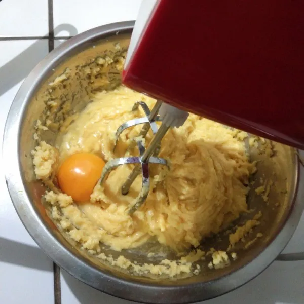 Mixer adonan dan tambahkan telur satu per satu dengan kecepatan tinggi.