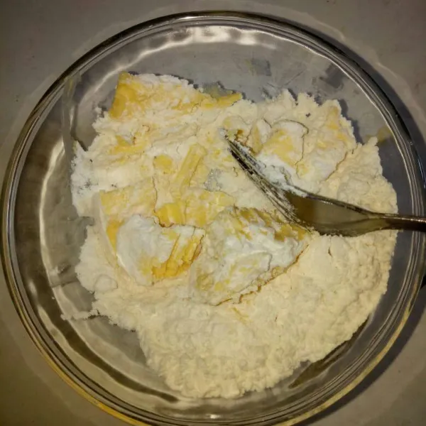 Siapkan wadah,masukan tepung terigu dan margarin beku. Hancurkan margarin pakai garpu sampai tercampur rata dengan terigu