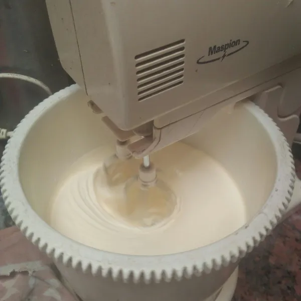 Setelah adonan kental putih berjejak kecilkan mixer.