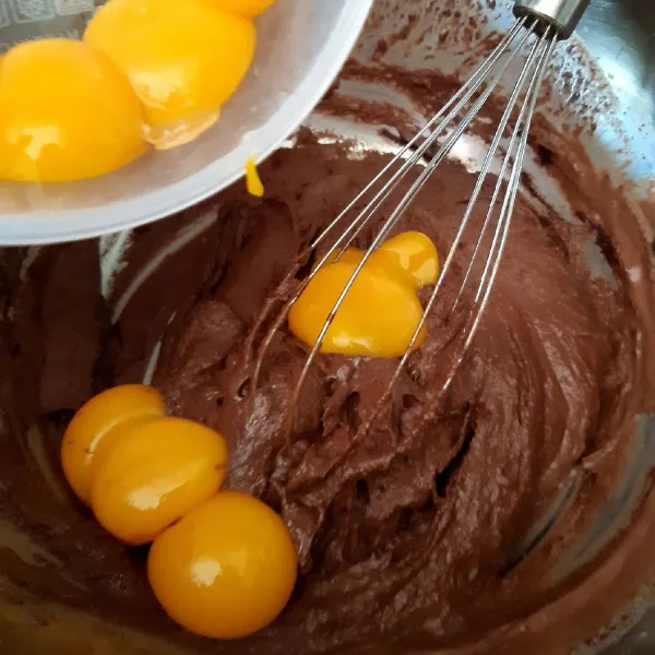Tambahkan kuning telur 1 per satu sambil diaduk dengan wisk.