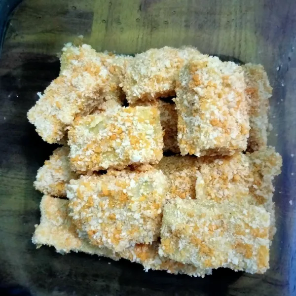 setelah 25 menit, angkat dinginkan adonan lalu potong-potong sesuai selera, siapkan bahan pelapis celup adonan ke tepung terigu berisi air lalu balurkan ke tepung panir lakukan sampai adonan habis semua. nugget bisa langsung di goreng atau simpan di dalam kulkas.
