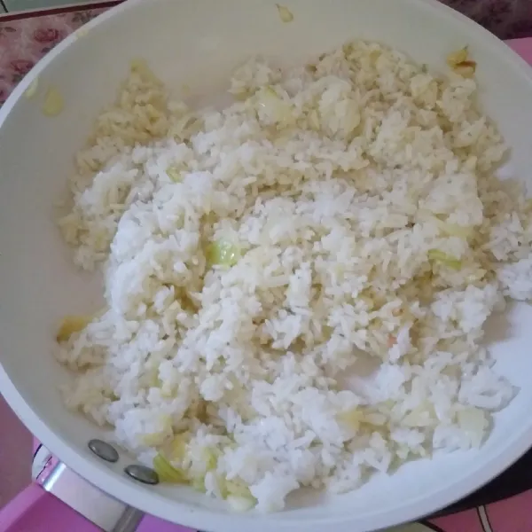 masukan nasi, garam, dan merica bubuk, aduk hingga bumbu rata. setelah matang, masukan ke dalam mangkuk, tambahkan ayam di atasnya, dan siram dengan saus keju, siap disajikan.