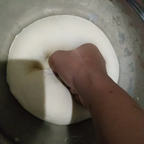 Setelah mengembang, tinju adonan agar udara keluar.