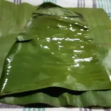 Ambil 2 lembar daun pisang. Tumpuk lalu lumuri permukaan daun pisang dengan minyak goreng.