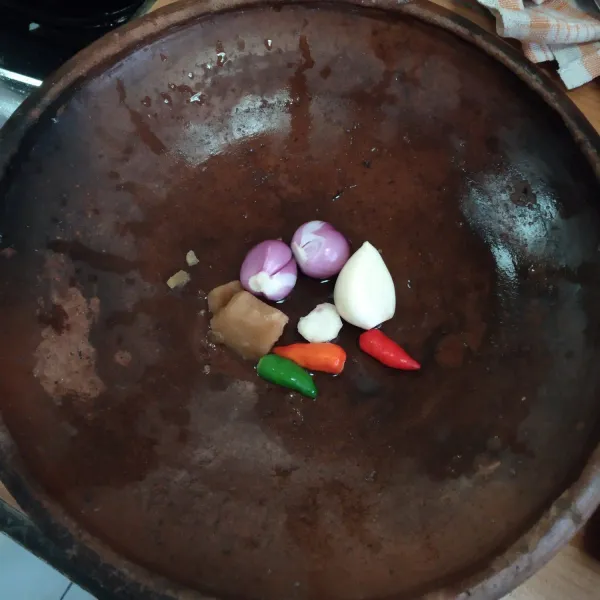 Haluskan bawang merah, bawang putih, kencur, cabai rawit dan gula jawa.