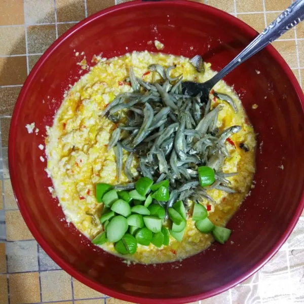 Masukan tahu, telur, santan, dan bumbu halus. Aduk rata, kemudian masukan ikan teri asin dan petai. Aduk rata kembali