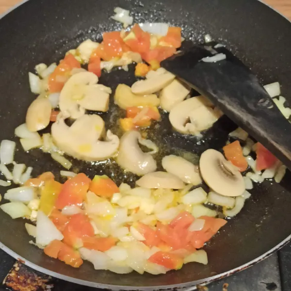 panaskan butter, masukkan bawang bombay dan bawang putih yang sudah dicincang. tumis hingga harum. Tambahkan tomat yang sudah dicincang dan jamur.